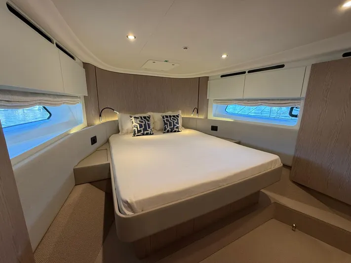  Yacht Photos Pics Luxurious bedroom interior of 2025 Azimut Fly 53 yacht with modern design and cozy bedding.