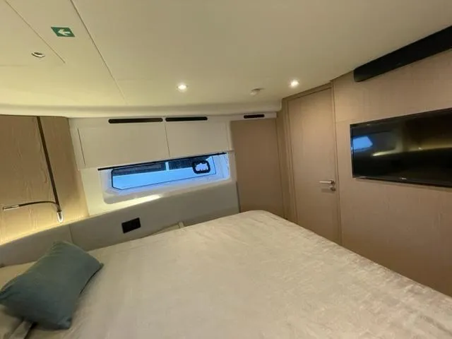  Yacht Photos Pics Luxurious bedroom interior of 2023 Azimut Fly 53 yacht with modern design and ambient lighting.