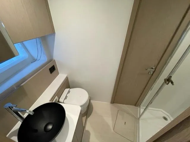  Yacht Photos Pics Modern bathroom in 2023 Azimut Fly 53 yacht with sleek fixtures and shower.
