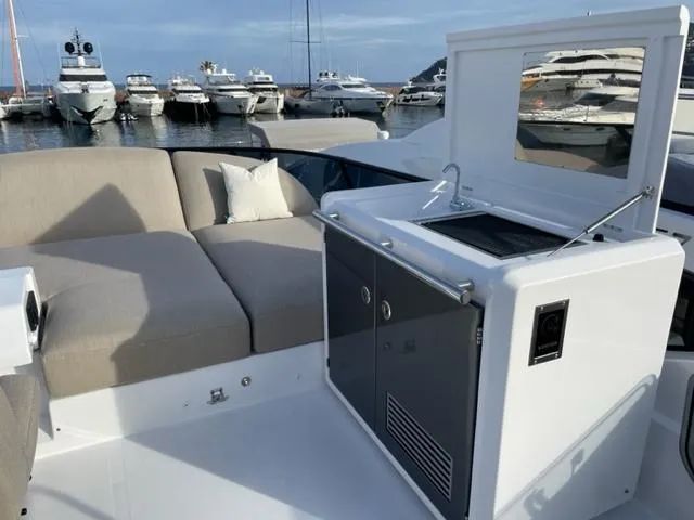  Yacht Photos Pics 2023 Azimut Fly 53 yacht deck with seating and kitchenette, docked at marina.