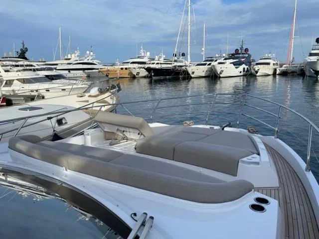  Yacht Photos Pics 2023 Azimut Fly 53 yacht docked in a marina with other luxury boats.
