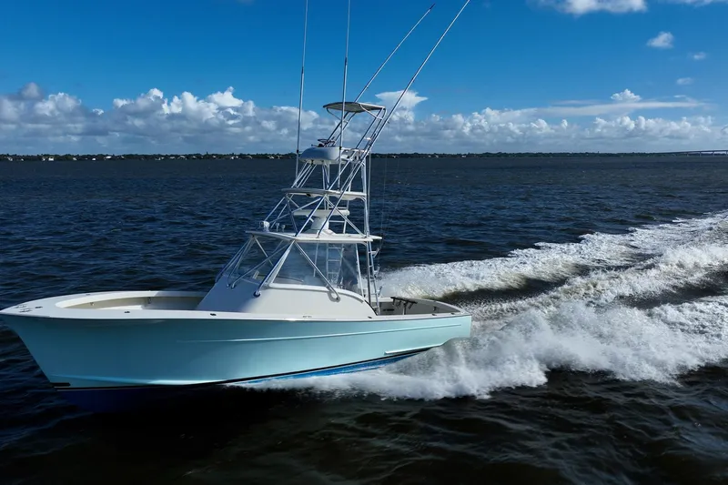 Reese Lee Yacht Photos Pics 2003 Gamefisherman 34 Express cruising on open water under a clear blue sky.
