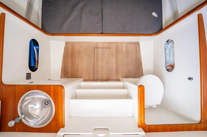 Reese Lee Yacht Photos Pics Interior of 2003 Gamefisherman 34 Express boat with sink and wooden accents.