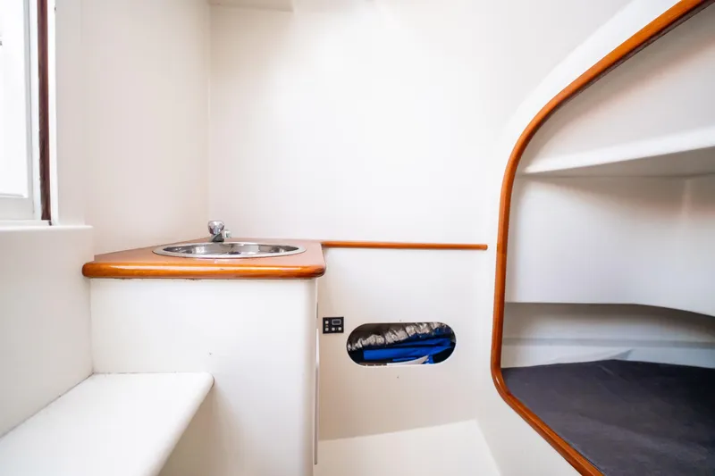 Reese Lee Yacht Photos Pics 2003 Gamefisherman 34 Express cabin interior with sink and cozy sleeping area.