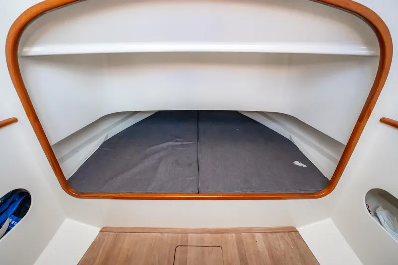 Reese Lee Yacht Photos Pics 2003 Gamefisherman 34 Express cabin interior with wooden trim and storage space.