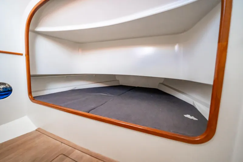 Reese Lee Yacht Photos Pics 2003 Gamefisherman 34 Express cabin interior with wooden trim and storage space.