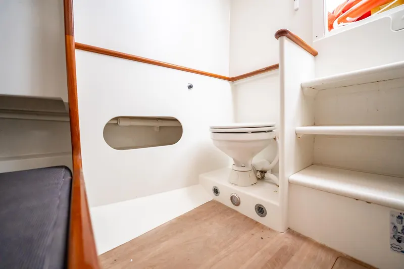 Reese Lee Yacht Photos Pics 2003 Gamefisherman 34 Express boat interior with toilet and wooden accents.