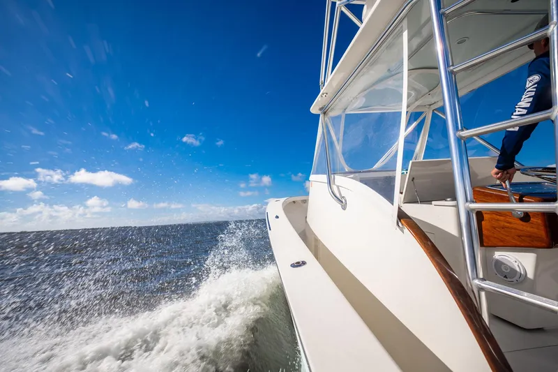 Reese Lee Yacht Photos Pics 2003 Gamefisherman 34 Express cruising on open water under clear blue skies.