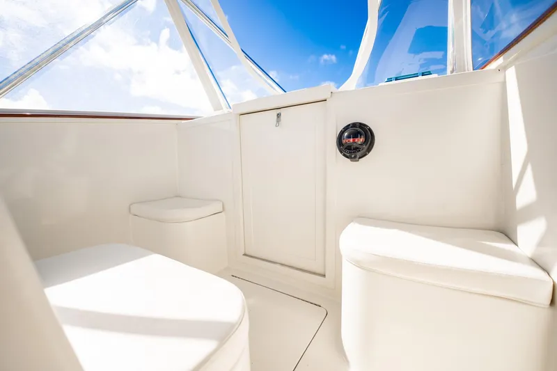 Reese Lee Yacht Photos Pics 2003 Gamefisherman 34 Express boat interior with white seating and clear windows.