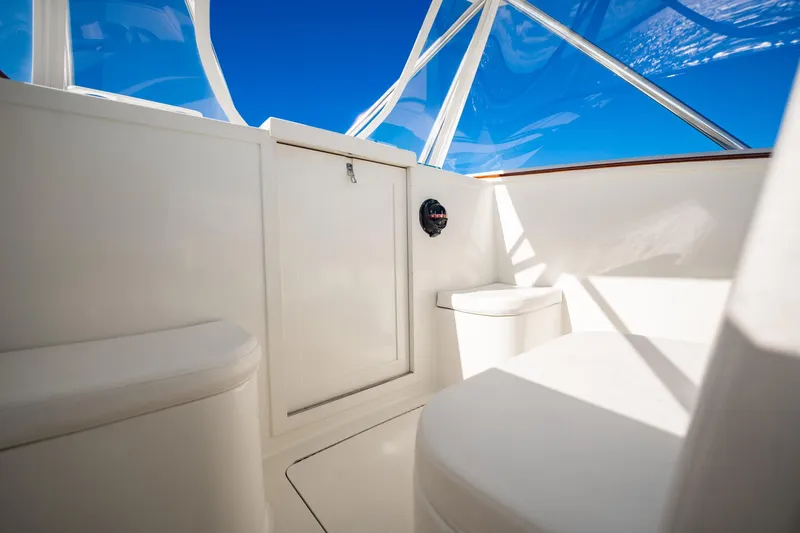 Reese Lee Yacht Photos Pics Interior of 2003 Gamefisherman 34 Express boat with white seating and clear canopy.