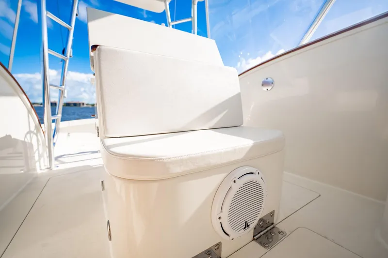 Reese Lee Yacht Photos Pics 2003 Gamefisherman 34 Express boat seating area with speaker, under clear blue sky.