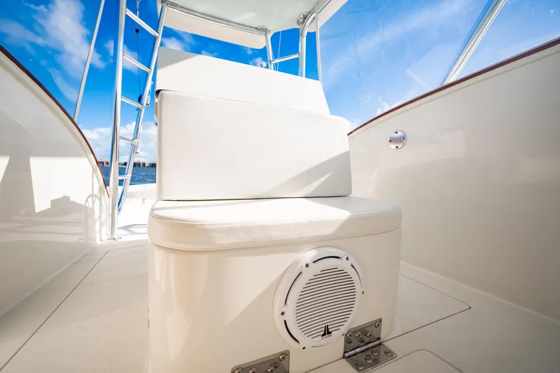 Reese Lee Yacht Photos Pics 2003 Gamefisherman 34 Express boat interior with seating and speaker, under clear blue sky.