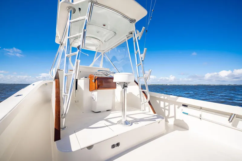 Reese Lee Yacht Photos Pics 2003 Gamefisherman 34 Express boat with tower, on open water under clear blue sky.