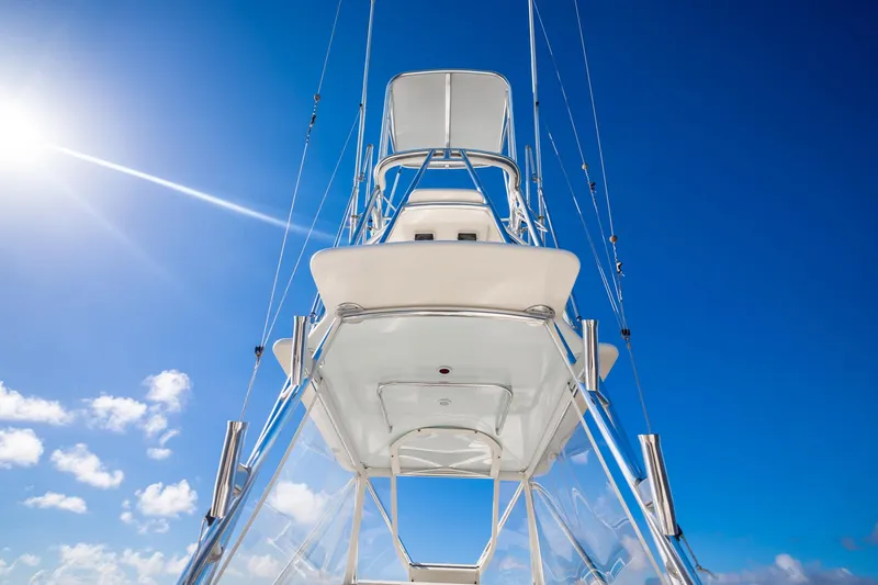 Reese Lee Yacht Photos Pics 2003 Gamefisherman 34 Express boat against a clear blue sky with bright sun.