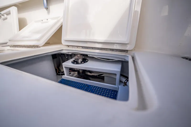 Reese Lee Yacht Photos Pics Open storage compartment on 2003 Gamefisherman 34 Express boat, showcasing interior details.