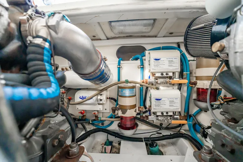 Reese Lee Yacht Photos Pics Engine room of 2003 Gamefisherman 34 Express, showcasing fuel filtering systems and components.