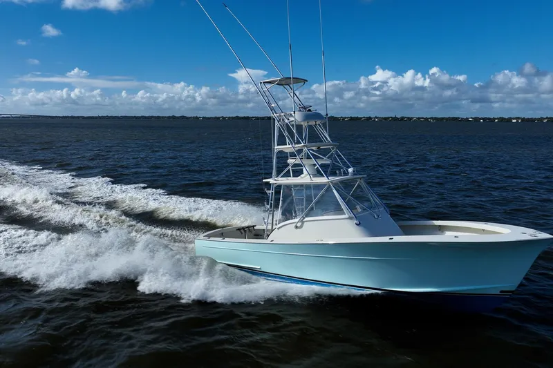 Reese Lee Yacht Photos Pics 2003 Gamefisherman 34 Express cruising on open water under a clear blue sky.