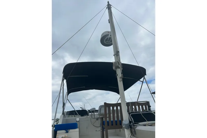  Yacht Photos Pics 2006 Mariner Orient sailboat with mast and canopy under cloudy sky.