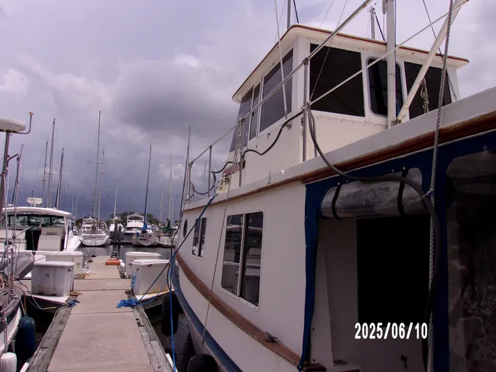 Chesapeake Yacht Photos Pics 1986 Kadey-Krogen Manatee 36 docked at marina under cloudy sky.