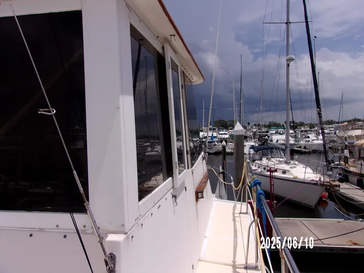 Chesapeake Yacht Photos Pics 1986 Kadey-Krogen Manatee 36 docked at marina, cloudy sky in background.