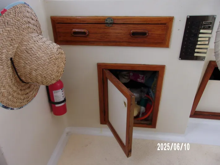 Chesapeake Yacht Photos Pics 1986 Kadey-Krogen Manatee 36 interior with storage, fire extinguisher, and control panel.