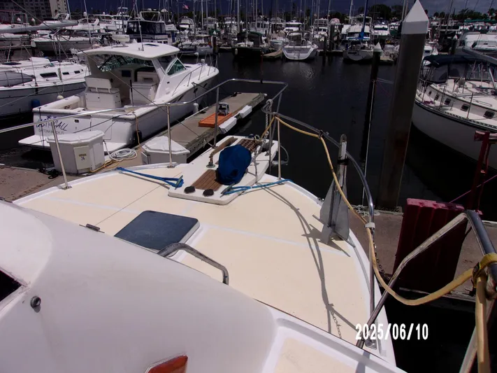 Chesapeake Yacht Photos Pics 1986 Kadey-Krogen Manatee 36 docked at a marina with other boats.
