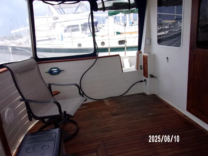 Chesapeake Yacht Photos Pics 1986 Kadey-Krogen Manatee 36 interior with wooden flooring and chair, docked at marina.