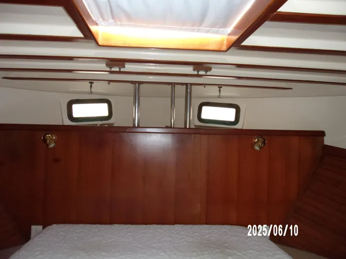 Chesapeake Yacht Photos Pics 1986 Kadey-Krogen Manatee 36 cabin interior with wood paneling and portholes.