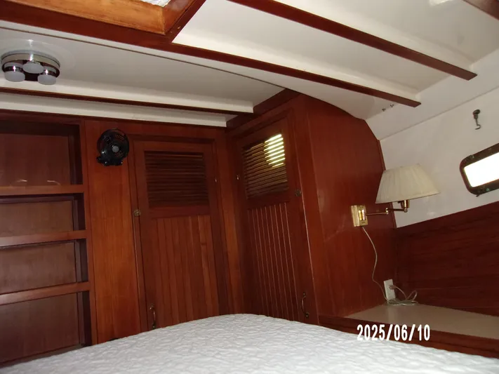 Chesapeake Yacht Photos Pics Interior cabin of 1986 Kadey-Krogen Manatee 36 with wooden furnishings and bed.