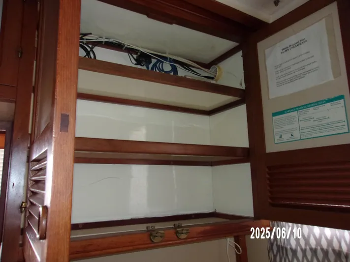 Chesapeake Yacht Photos Pics Empty wooden cabinet inside 1986 Kadey-Krogen Manatee 36 boat, with visible wiring.
