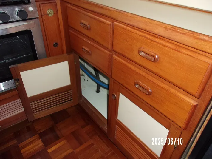 Chesapeake Yacht Photos Pics 1986 Kadey-Krogen Manatee 36 interior with wooden cabinets and open storage space.