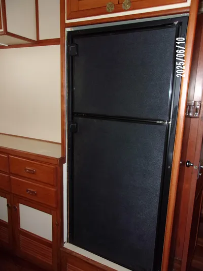 Chesapeake Yacht Photos Pics 1986 Kadey-Krogen Manatee 36 interior with wooden cabinetry and built-in refrigerator.